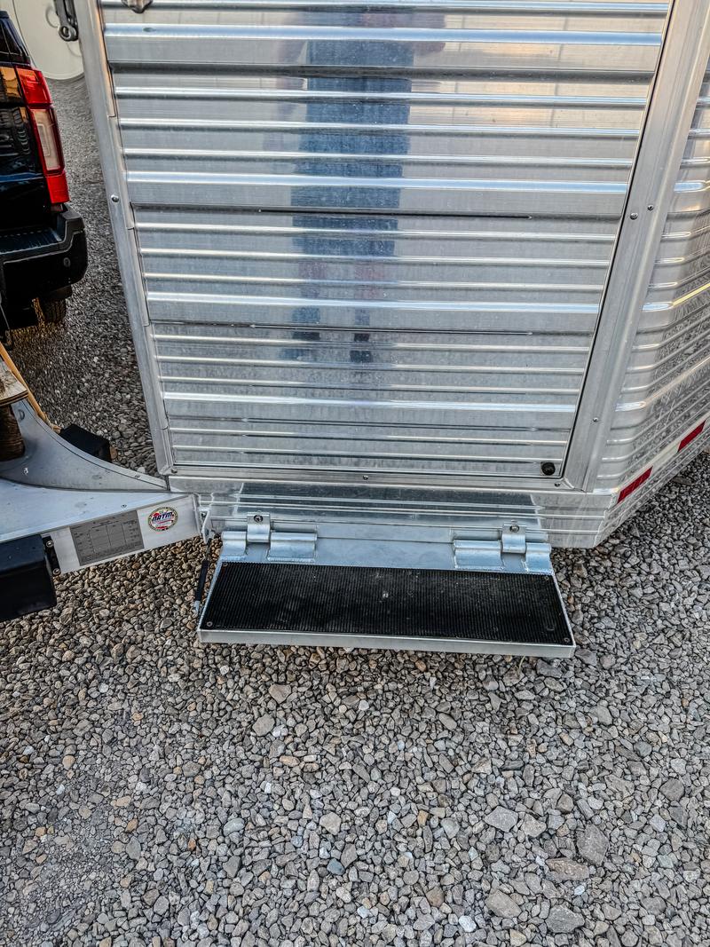 Fold-down step beneath dressing room door