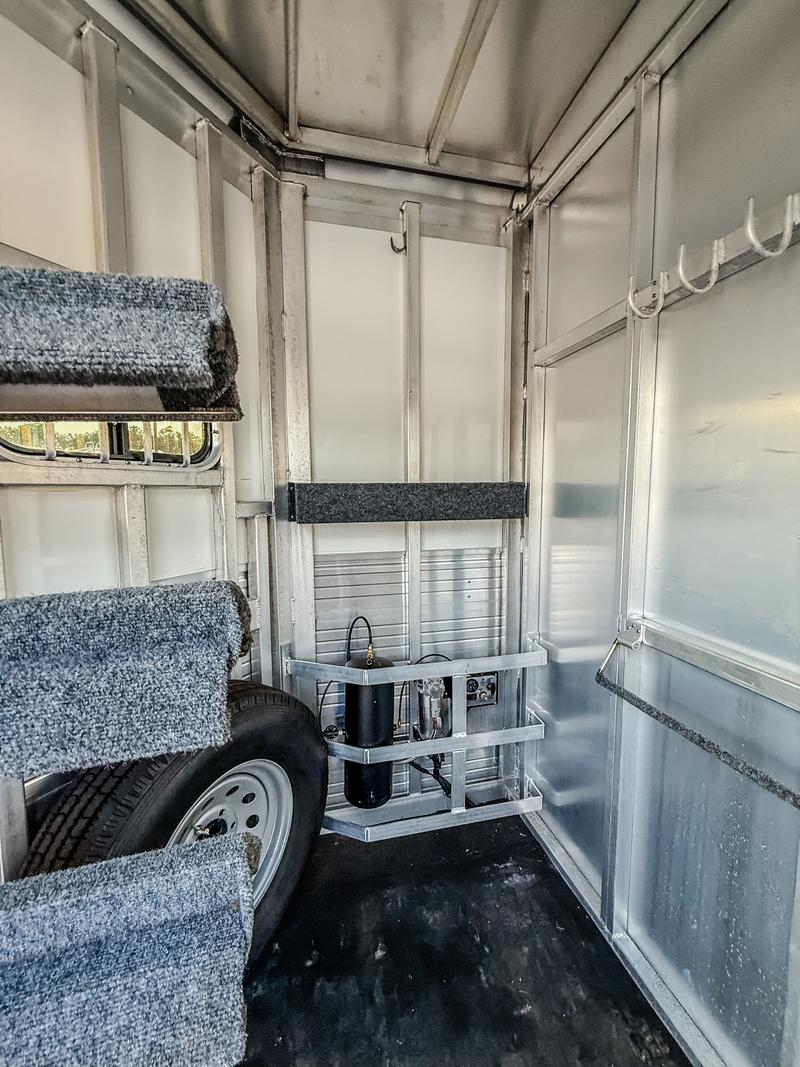 Inside tack room with spare tire and shelf storage